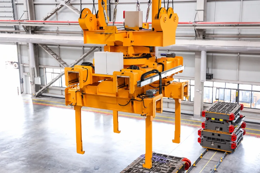Adjustable die lifting attachment with telescoping guides, a rotation assembly and hooked lifting arms