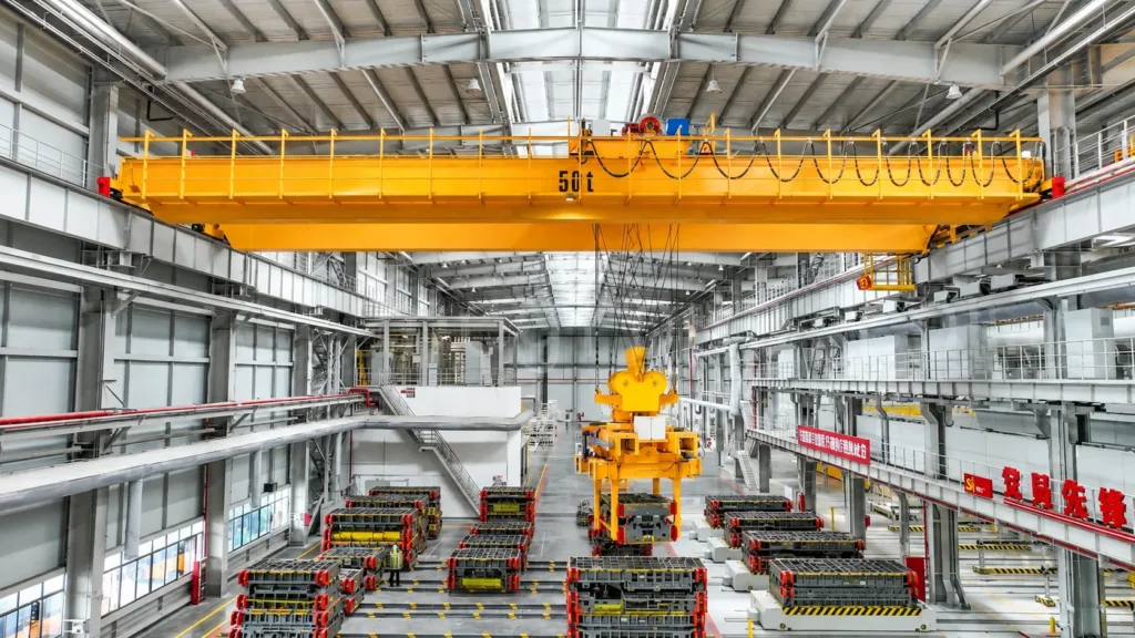 Crane and dedicated lifting attachment above rows of stored dies