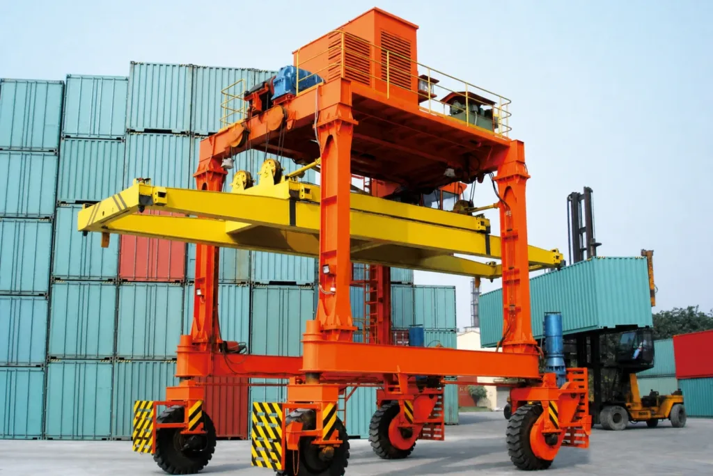 Container straddle carrier with spreader, wheels and full operating frame visible