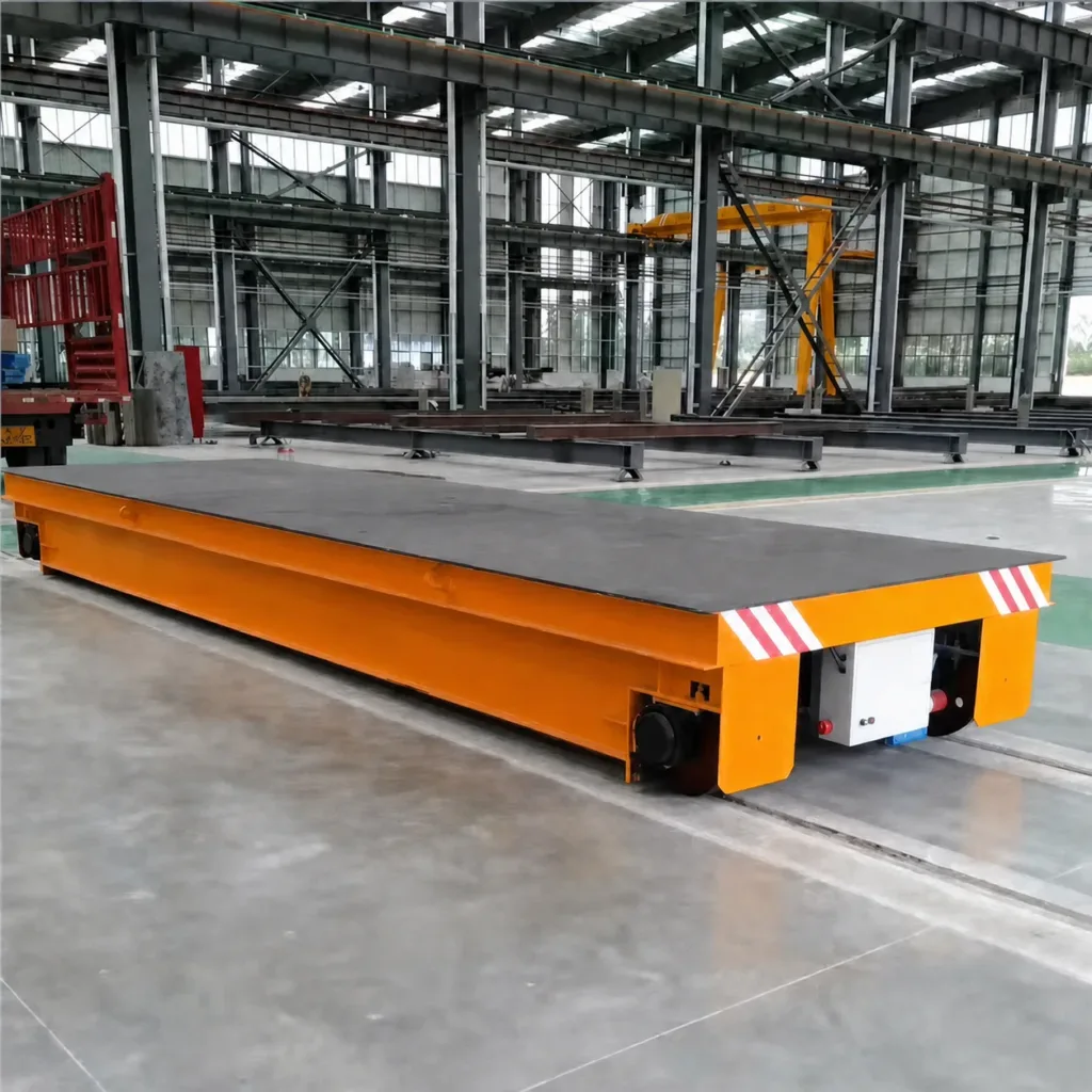 Low flat-deck rail transfer cart on a pair of floor rails