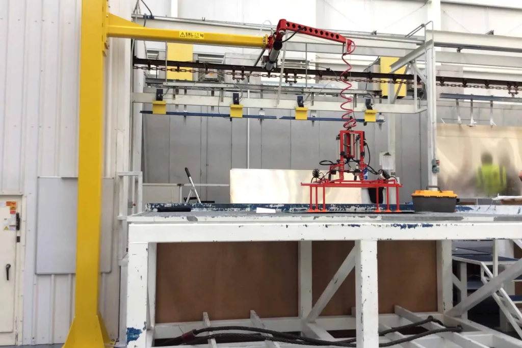 Articulating jib crane serving a local industrial handling station