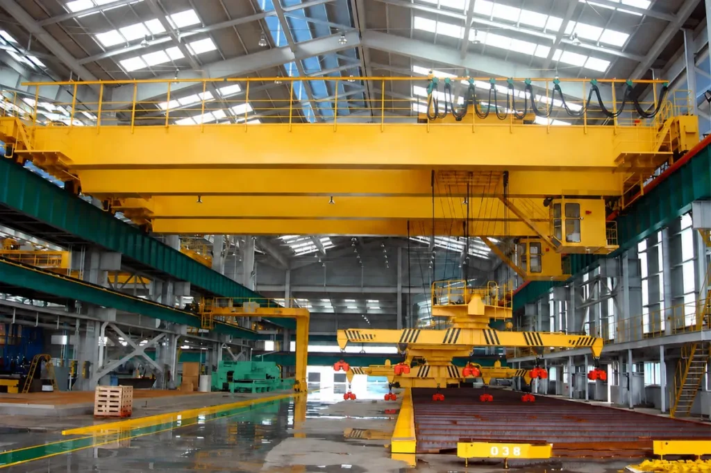 Overhead crane with a rotating lifting beam and multiple magnet units above long steel stock