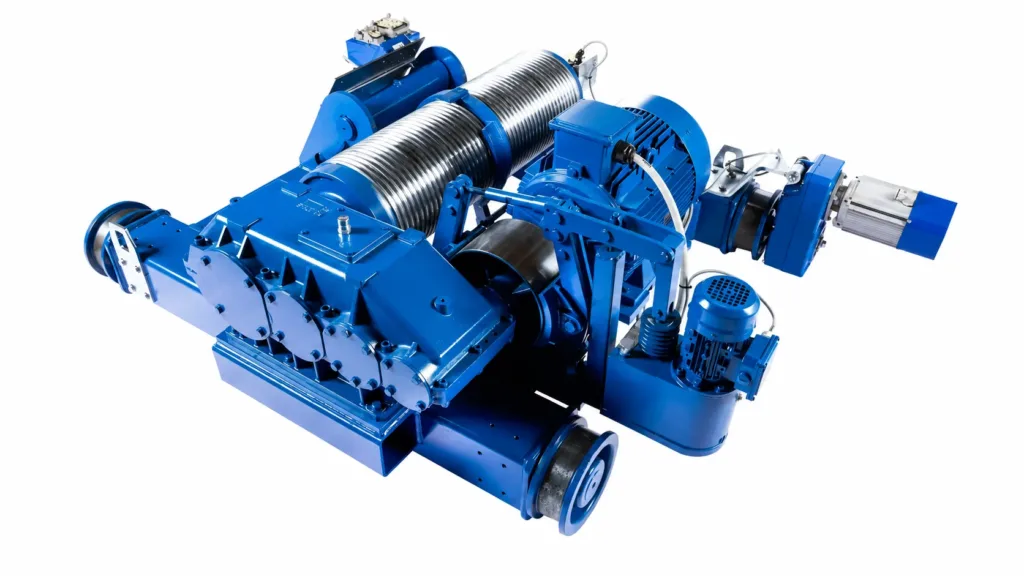 Open winch trolley viewed from above, showing the grooved drum, motor, gearbox, hydraulic thruster brake, frame and travel wheels