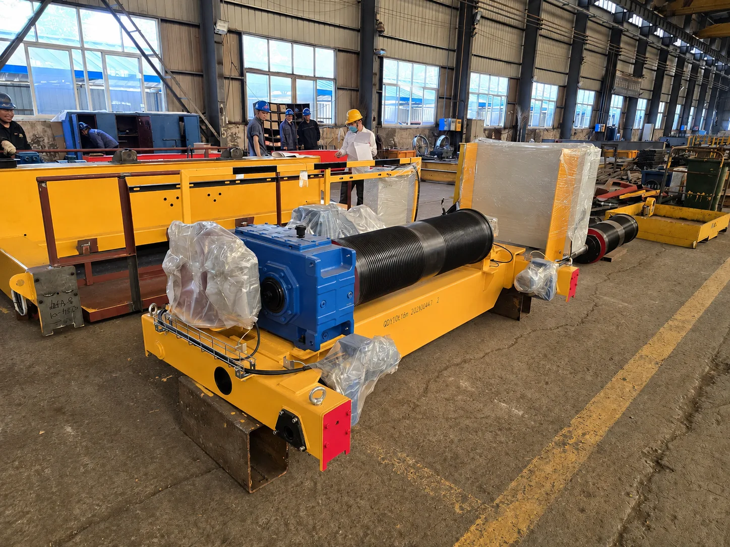 Open winch trolley during factory assembly, with grooved drum, blue gearbox, yellow frame and protected components