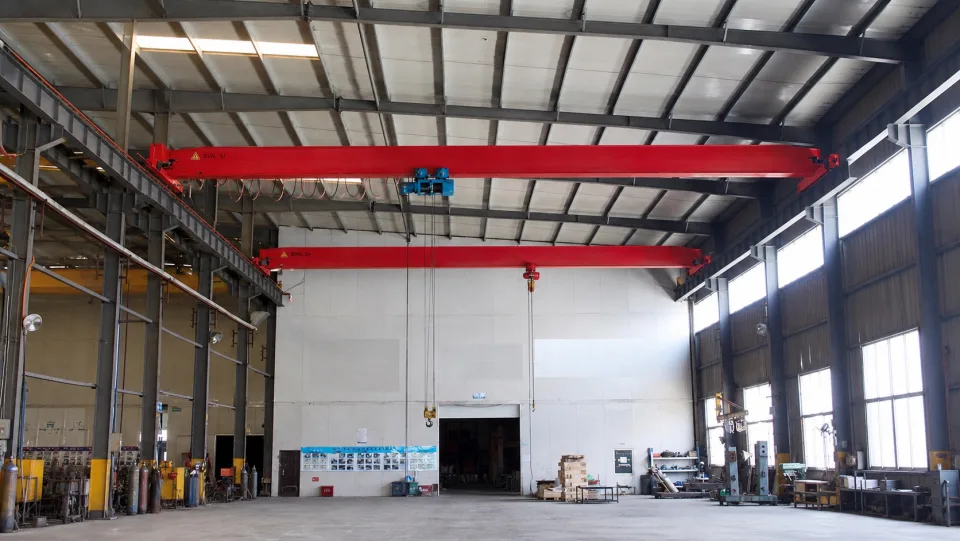 Two single-girder overhead cranes installed across a production bay