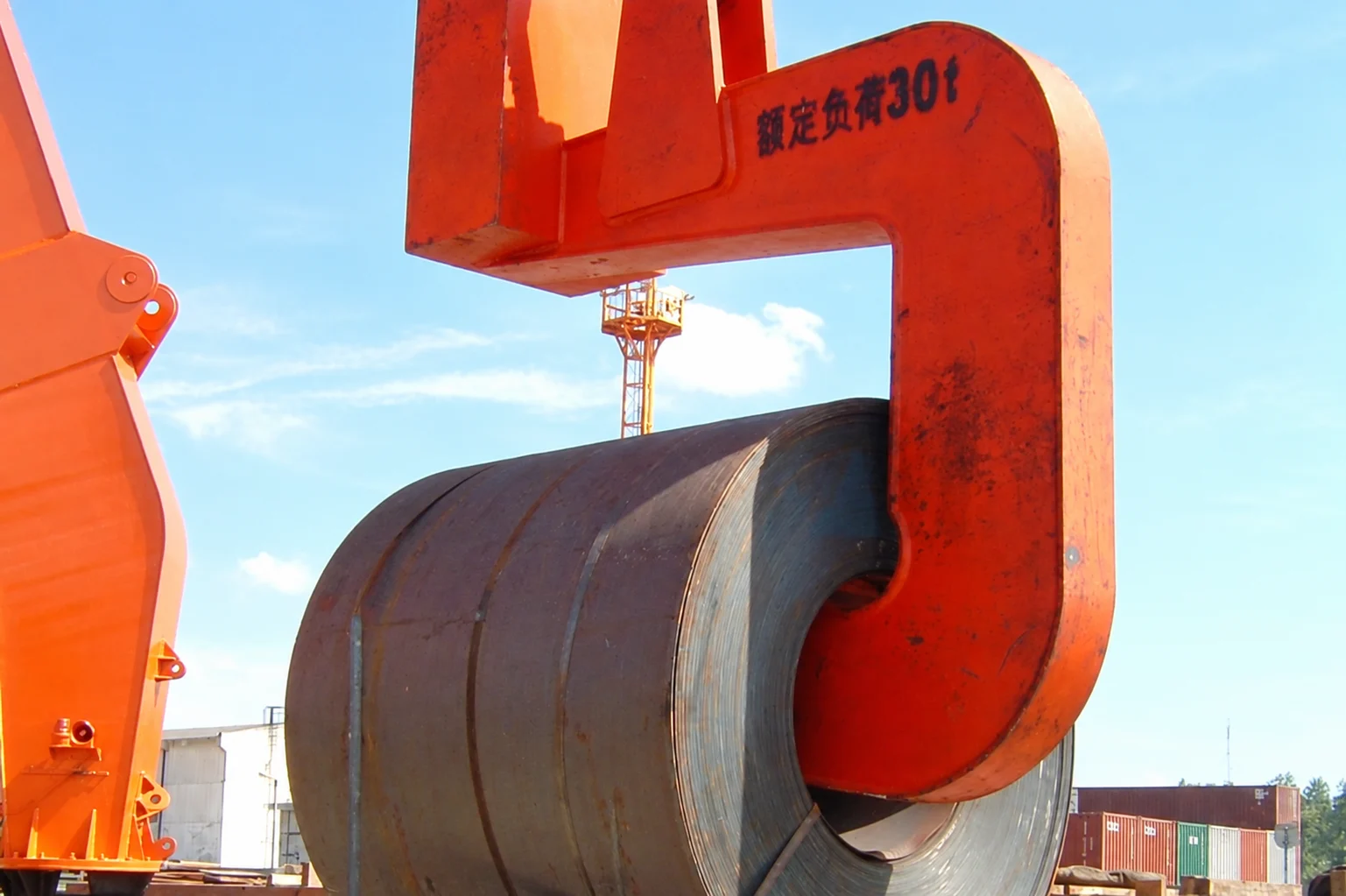 C-hook supporting a steel coil through its horizontal bore, with the equipment rating visible