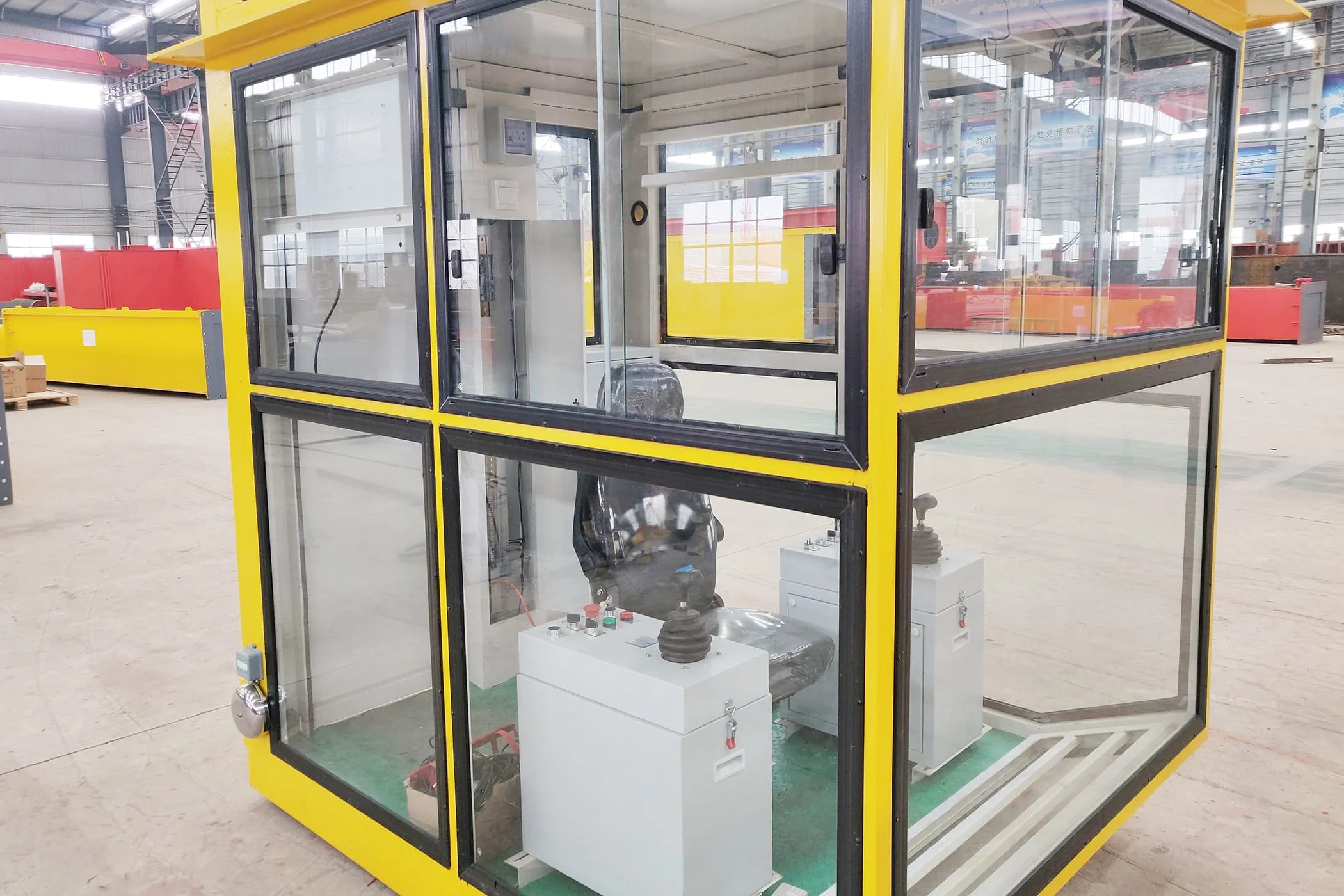Actual crane cabin with glazed windows, seat and joystick consoles