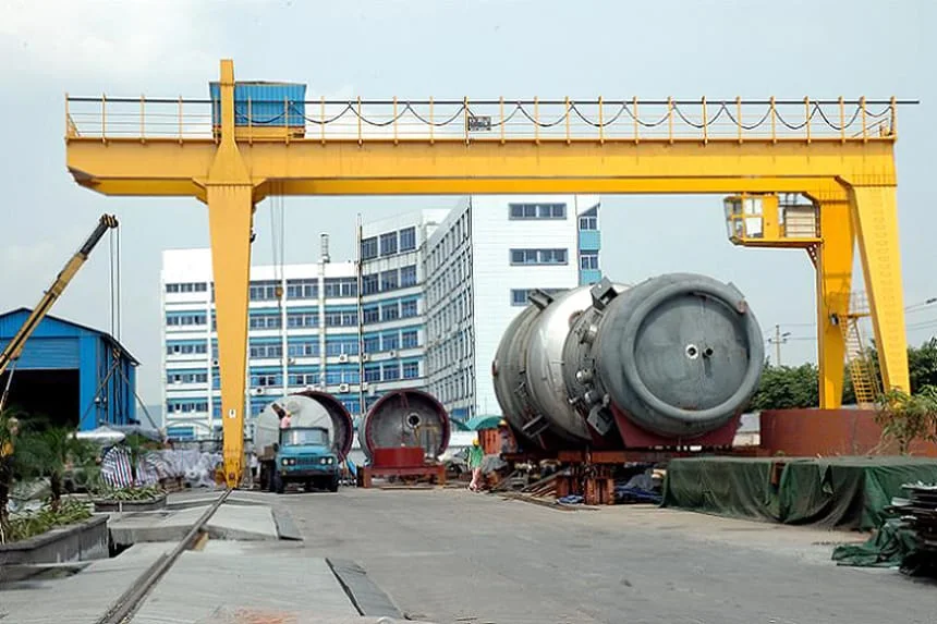 Crane cabin mounted on a gantry crane in an outdoor fabrication yard