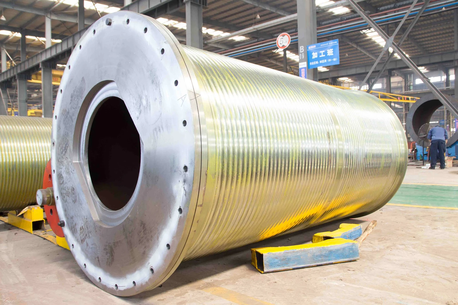 Machined rope drum with an open flanged end in a manufacturing workshop