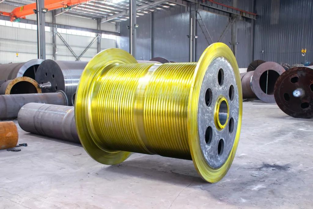 Grooved steel rope drum with end flanges in a workshop