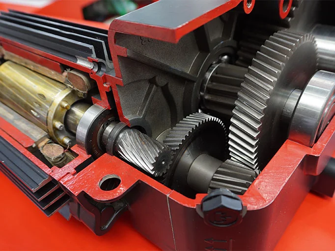Physical cutaway gearbox display showing the internal gears and shaft connection