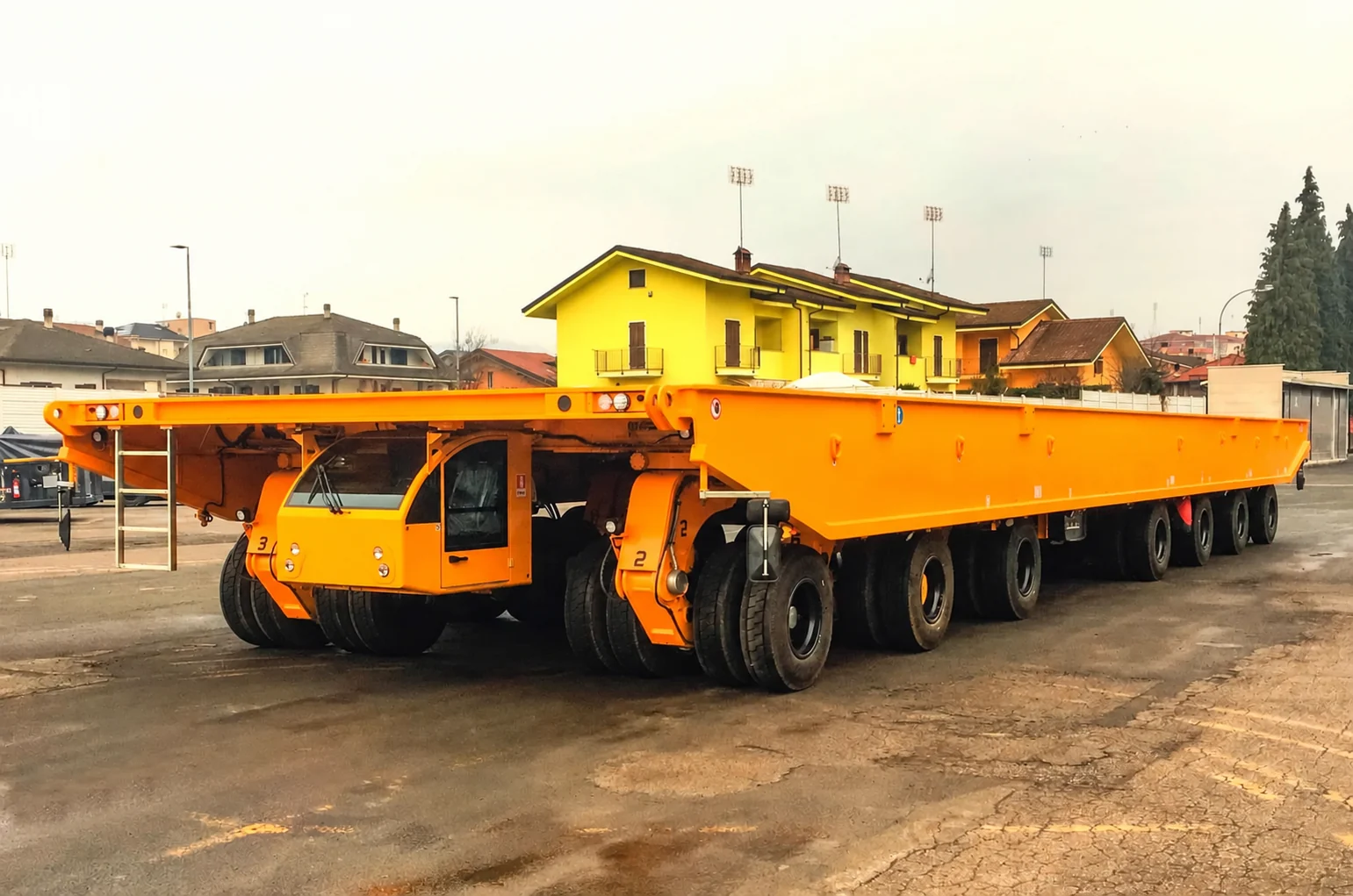 Multi-axle hydraulic platform transporter with deep deck frame and low-mounted cab