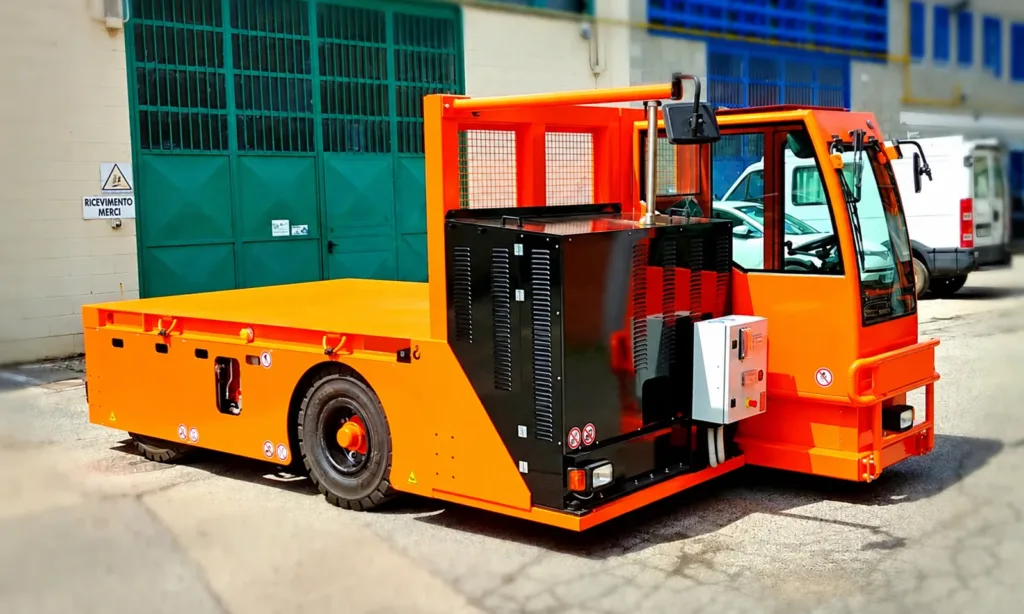 Battery-powered industrial platform truck with fixed load deck and driver cab