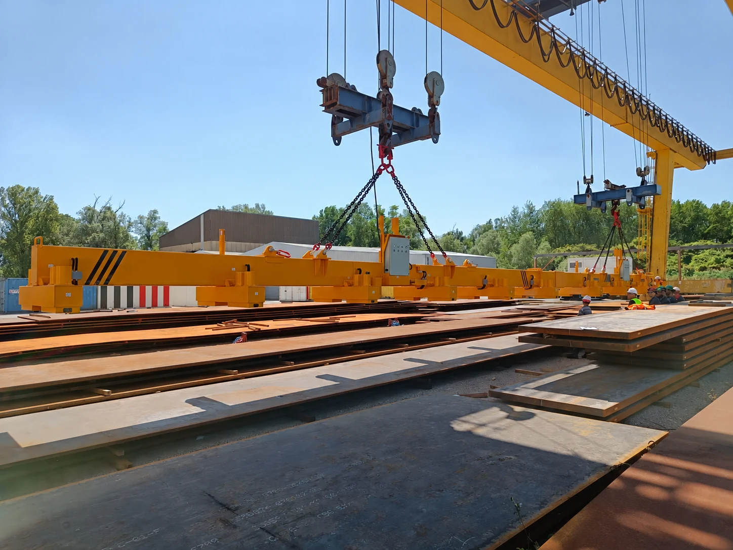 Magnetic beam positioned over steel plates outdoors
