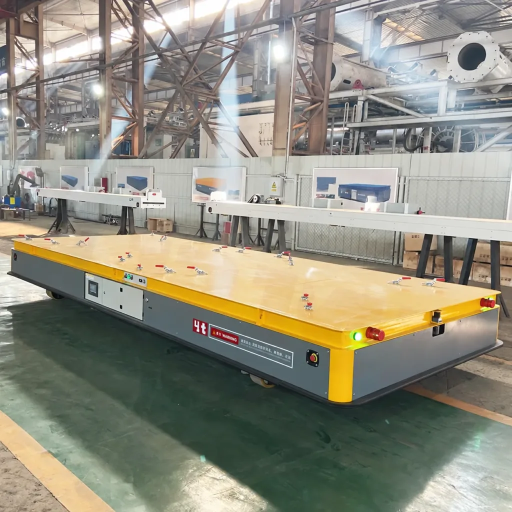 Yellow and gray production-line platform with deck clamps, controls and visible wheel openings