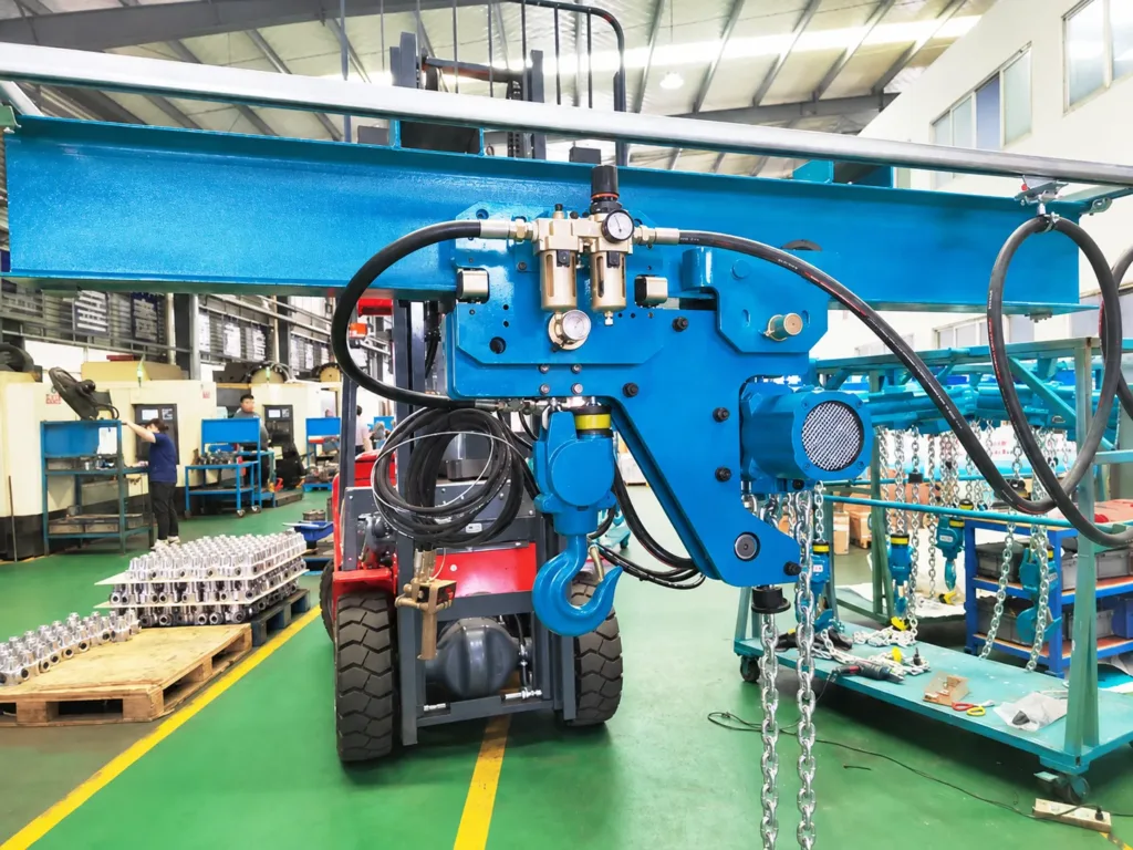 Low-headroom pneumatic chain hoist in a workshop, with beam mounting, air hoses and filter-regulator gauges