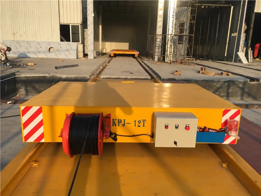 Cable-reel rail transfer cart showing reel, control box and warning beacon