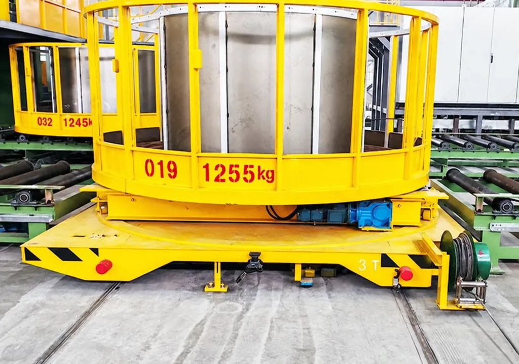 Rail transfer cart carrying a large cylindrical assembly in a support frame
