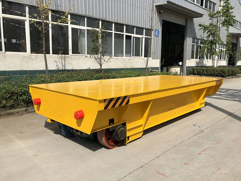 Complete yellow flat-deck rail cart with visible wheel assemblies