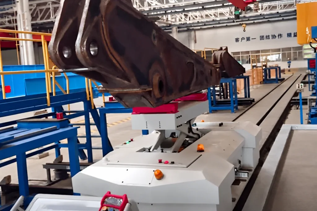 Large irregular workpiece carried on a dedicated support on a rail-guided vehicle