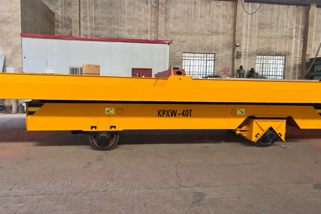 Side view of a trackless cart showing two different wheel assemblies beneath the deck