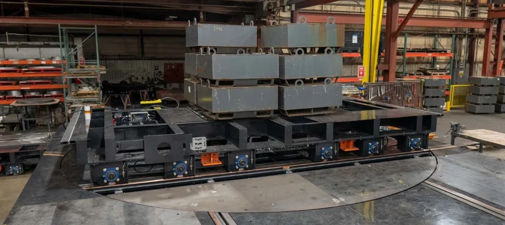 Loaded steel cart on a flush-floor circular turntable with connecting rails