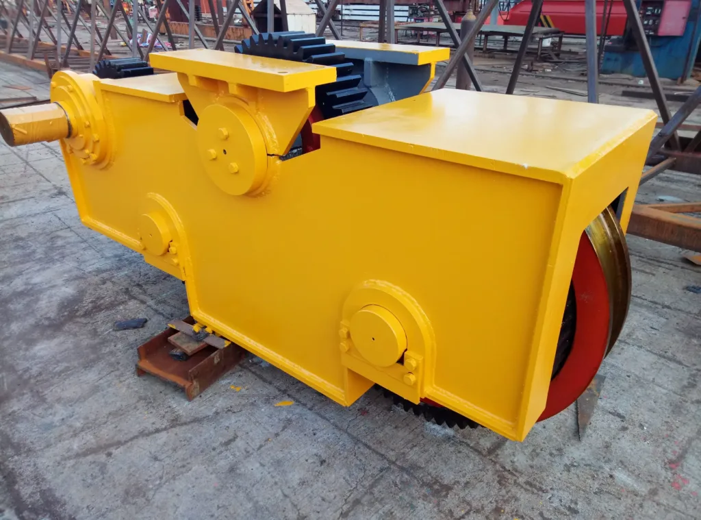 Crane trolley travel assembly with visible external wheel gearing