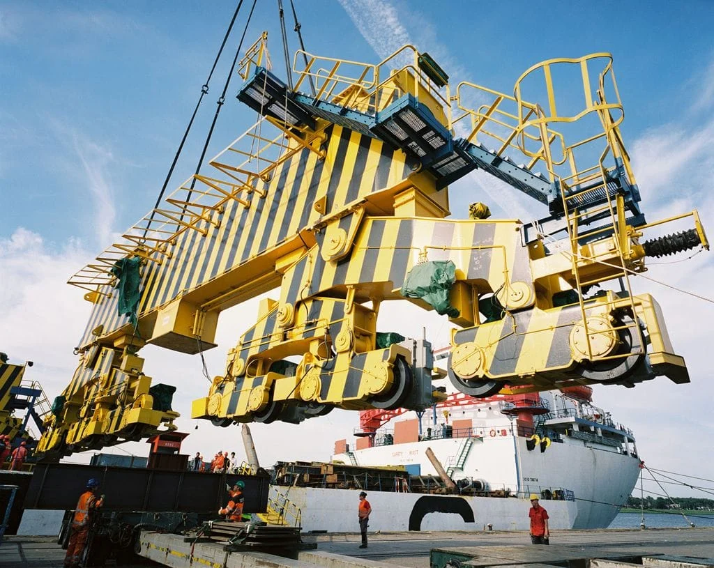 Multi-wheel articulated crane travel bogies being handled before installation