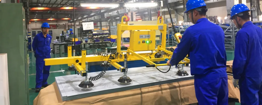 Vacuum sheet lifting equipment at a metal processing workstation