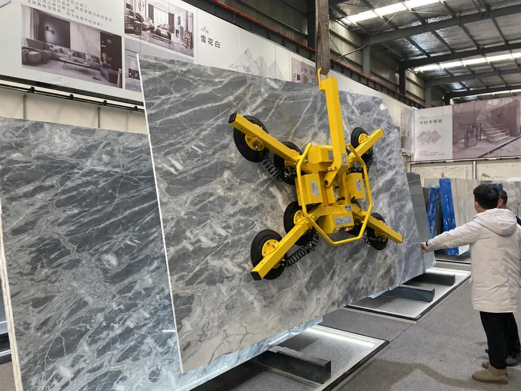 Vacuum lifting attachment holding a stone slab