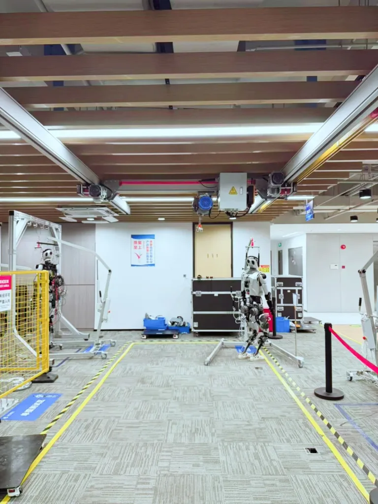 Humanoid robots and overhead aluminium bridge equipment in a robot test laboratory