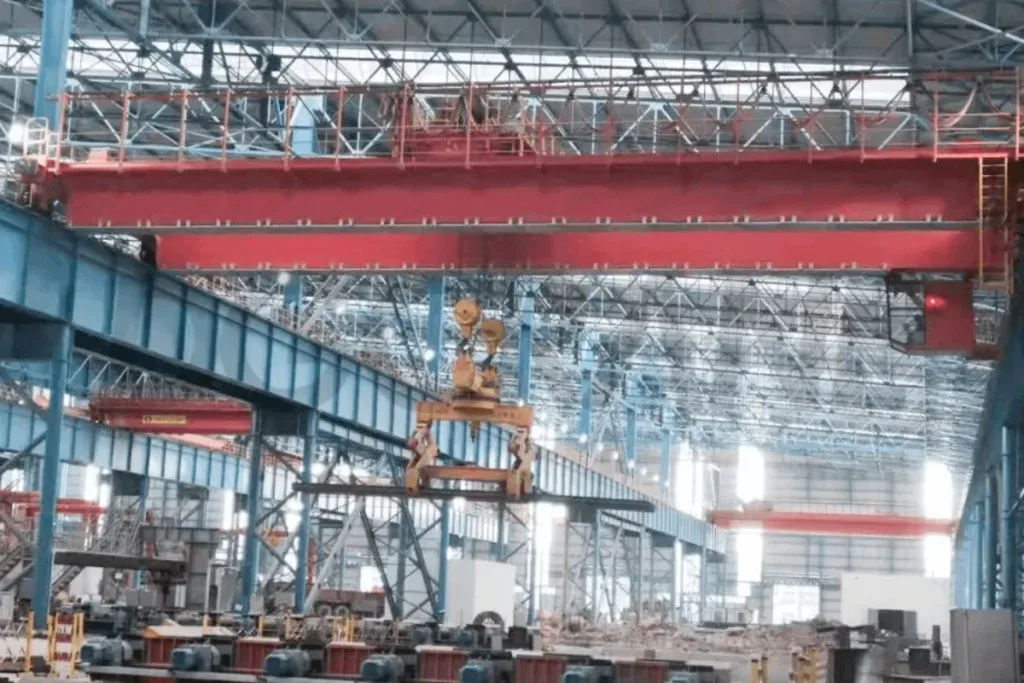 Installed overhead crane with slab tongs in a steel production bay