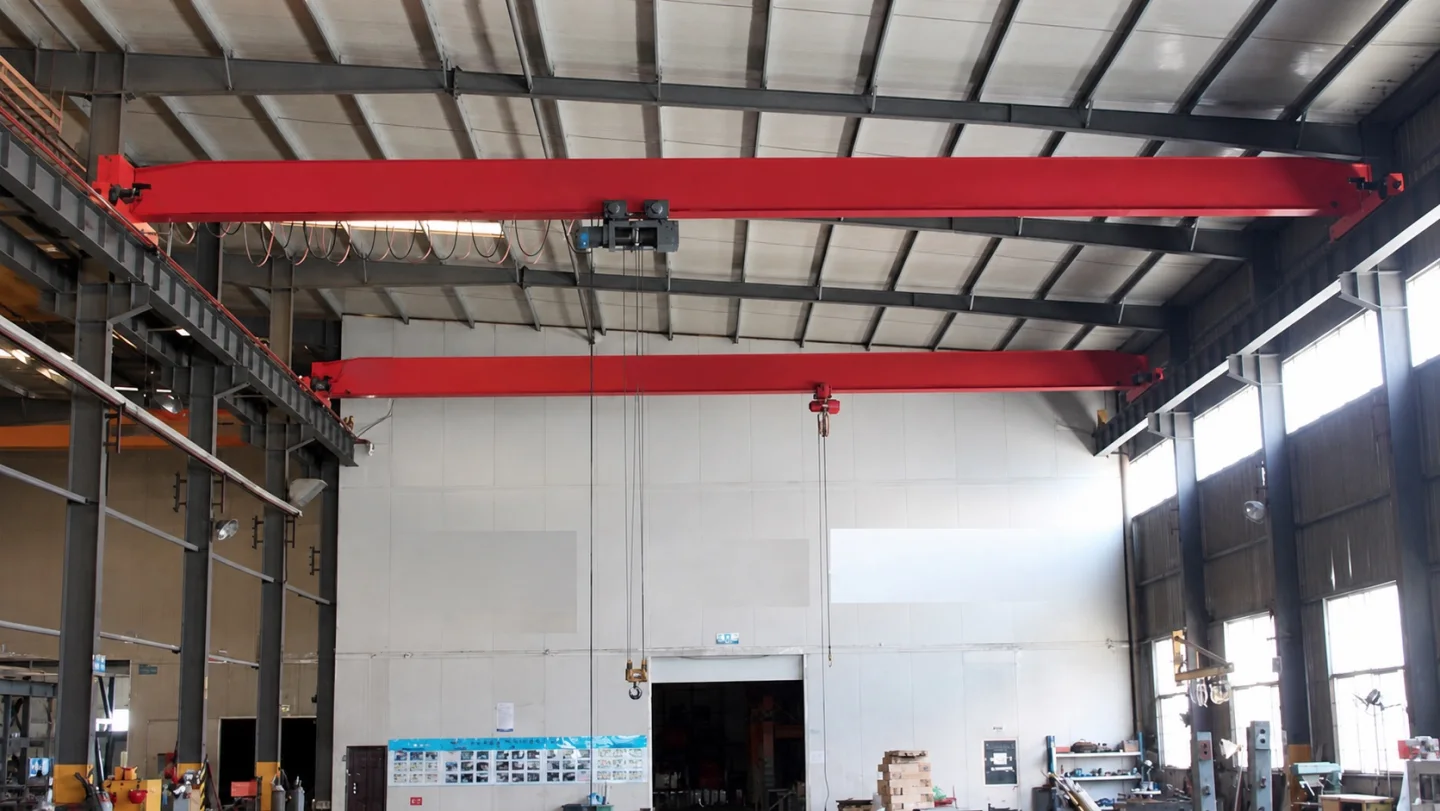 Installed overhead cranes serving parallel production routes across a working bay