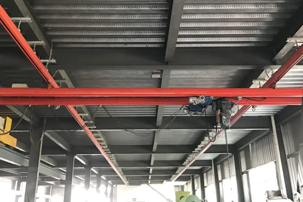Workstation crane suspended from an overhead support structure